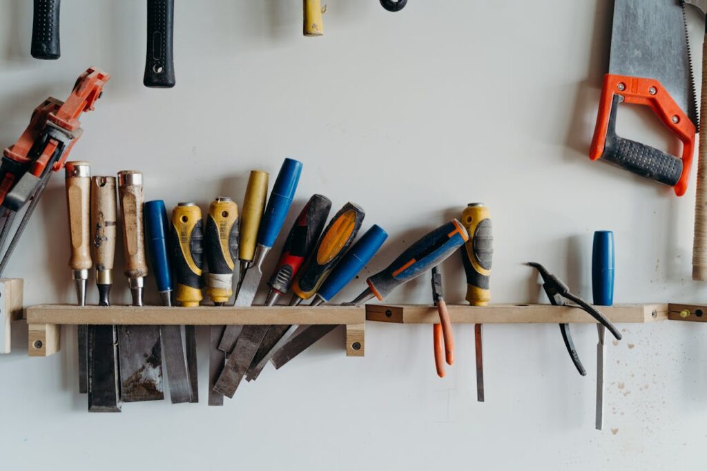 Carpentry Tools Hanging Beside a Wall