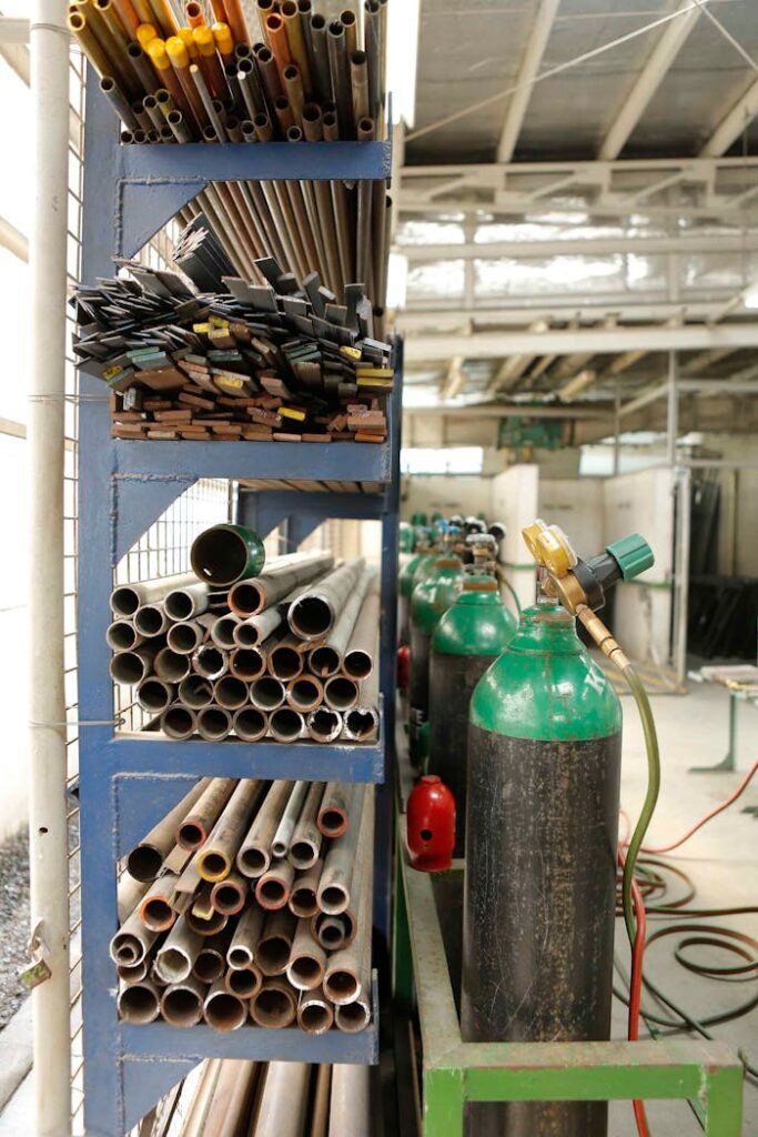 Warehouse with Metal Pipes and Welding Bottles